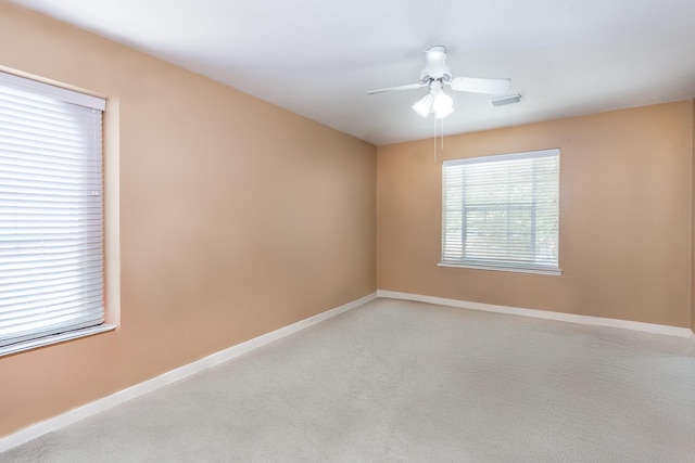 unfurnished room with light carpet and ceiling fan