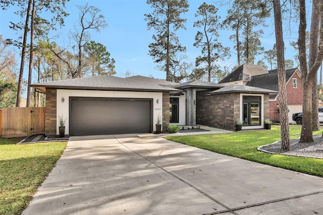 view of front of property with a garage and a front yard