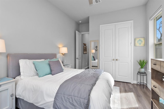 bedroom featuring light hardwood / wood-style floors and a closet