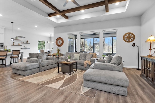 living room featuring coffered ceiling, ceiling fan, beam ceiling, hardwood / wood-style floors, and a high ceiling