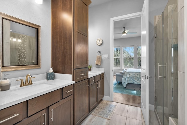 bathroom featuring vanity, tile patterned floors, an enclosed shower, and ceiling fan