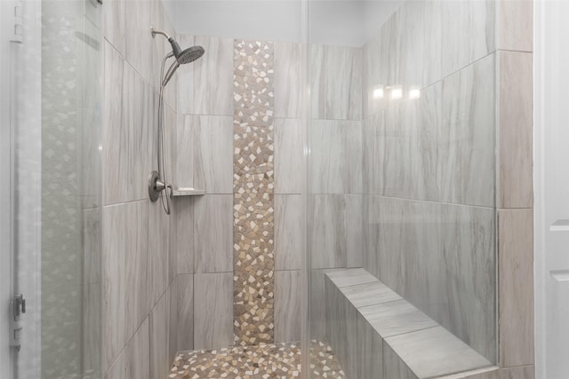 bathroom featuring tiled shower