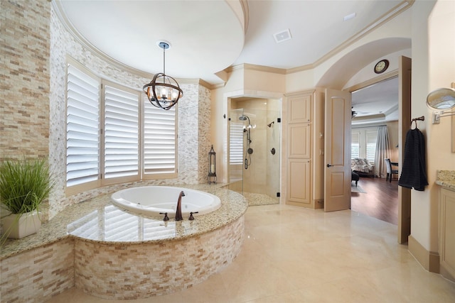 bathroom with visible vents, ornamental molding, a garden tub, a shower stall, and a chandelier