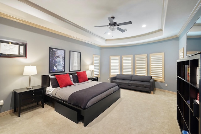 bedroom featuring baseboards, a tray ceiling, crown molding, and light colored carpet