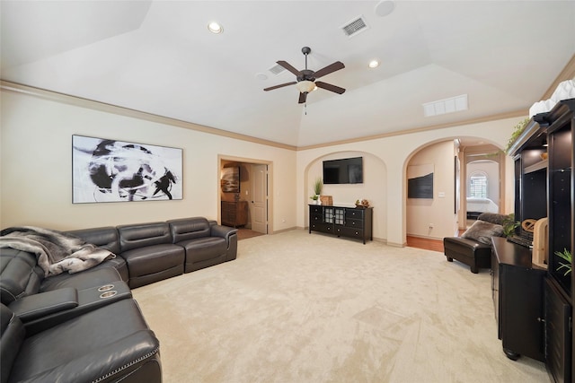 living area with ornamental molding, arched walkways, visible vents, and light carpet