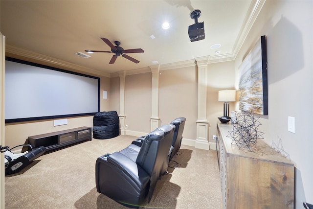 cinema room with crown molding, visible vents, a ceiling fan, and ornate columns