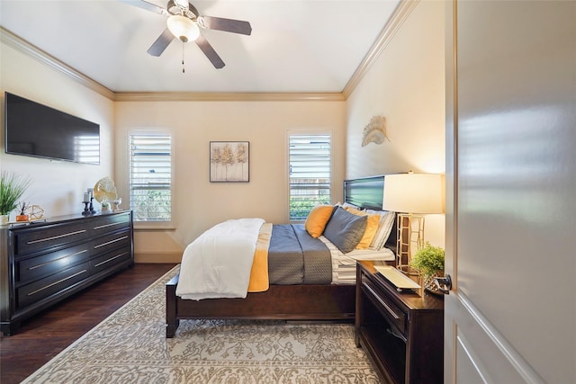 bedroom featuring ceiling fan, dark wood-type flooring, baseboards, and crown molding