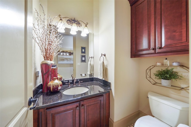 bathroom with toilet and vanity