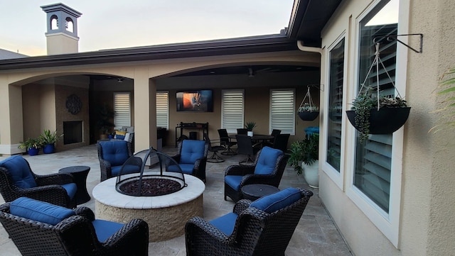 view of patio featuring outdoor dining area and a fire pit