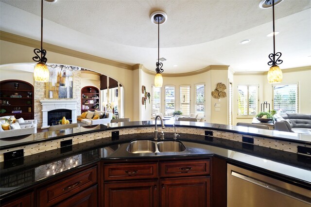 kitchen featuring dark countertops, open floor plan, a sink, and stainless steel dishwasher