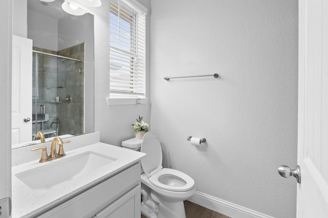 bathroom with toilet, wood-type flooring, vanity, and walk in shower