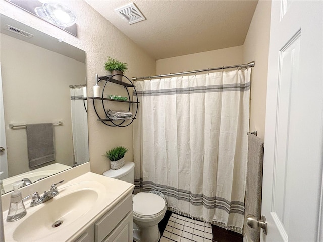 bathroom featuring vanity, toilet, a shower with shower curtain, and a textured ceiling