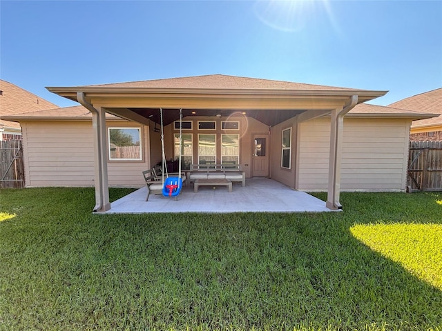 rear view of house featuring a patio area and a lawn