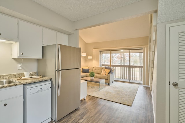 kitchen with white cabinetry, dishwasher, stainless steel fridge, dark wood-type flooring, and a textured ceiling