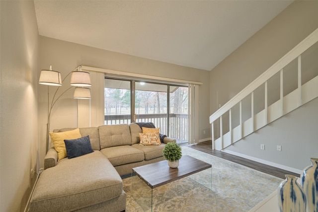 living room featuring wood-type flooring and lofted ceiling