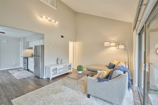 living room with dark hardwood / wood-style flooring, high vaulted ceiling, and ceiling fan