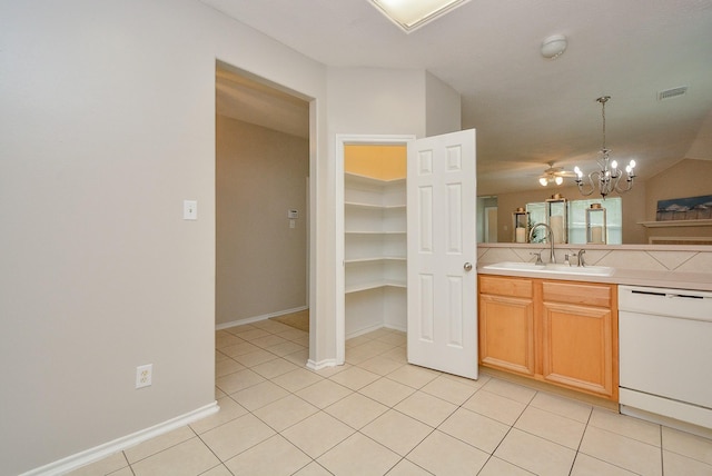 kitchen featuring sink, an inviting chandelier, hanging light fixtures, light tile patterned floors, and dishwasher