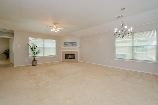 unfurnished living room featuring lofted ceiling, a fireplace, light colored carpet, and ceiling fan