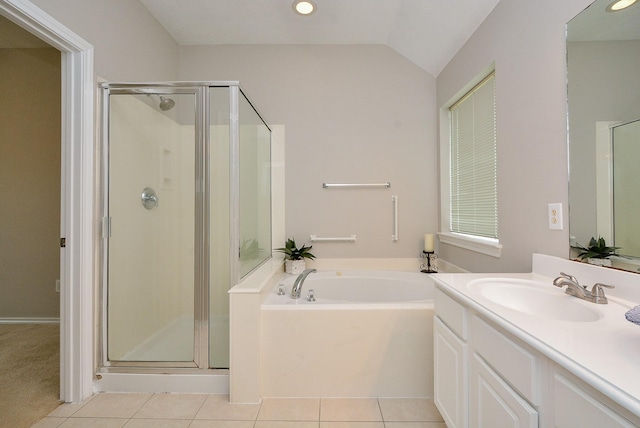 bathroom featuring vaulted ceiling, vanity, shower with separate bathtub, and tile patterned flooring