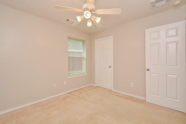 empty room featuring light carpet and ceiling fan