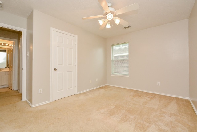 unfurnished bedroom featuring light carpet and ceiling fan