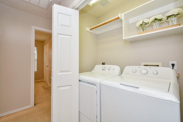 laundry room featuring light colored carpet and washing machine and dryer