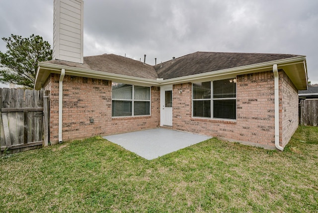 rear view of property featuring a patio area and a lawn