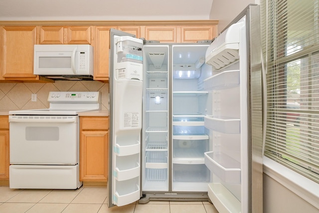 kitchen with backsplash, white appliances, light brown cabinets, and light tile patterned floors