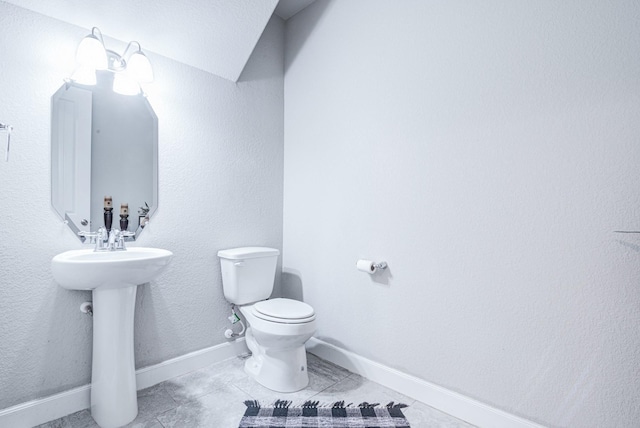 bathroom featuring sink, tile patterned floors, and toilet