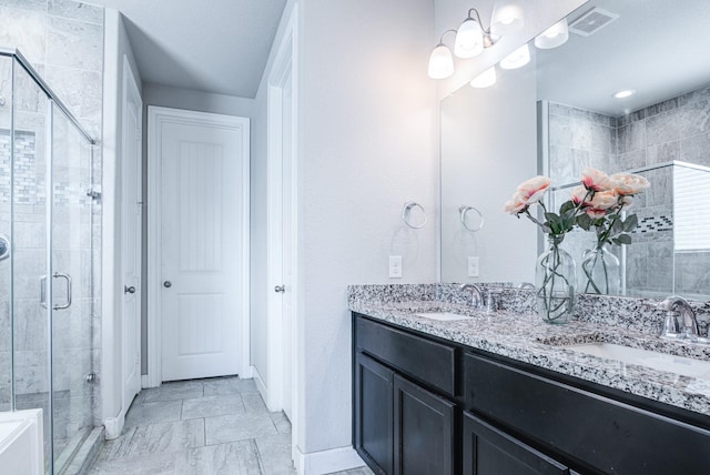 bathroom with vanity and a shower with shower door