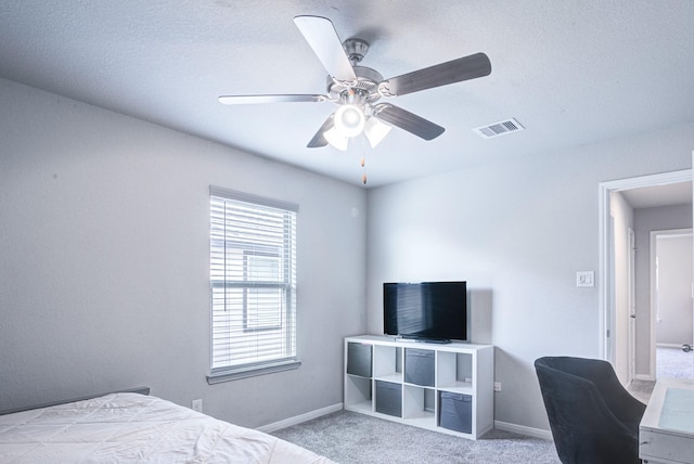 bedroom with ceiling fan and light carpet