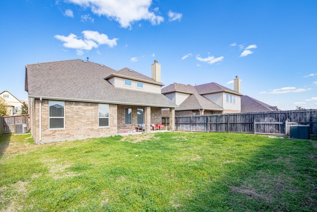 back of house with a yard, cooling unit, and a patio area