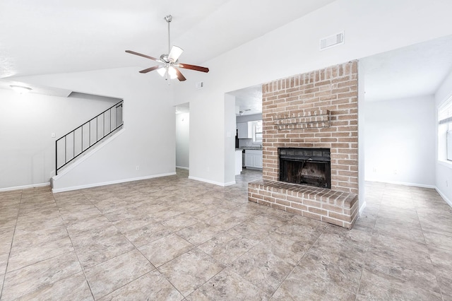 unfurnished living room with a brick fireplace, lofted ceiling, and ceiling fan