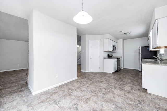 kitchen featuring white cabinetry, sink, decorative light fixtures, and stainless steel appliances