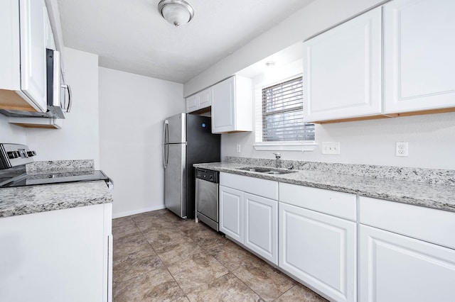 kitchen with sink, white cabinets, and appliances with stainless steel finishes