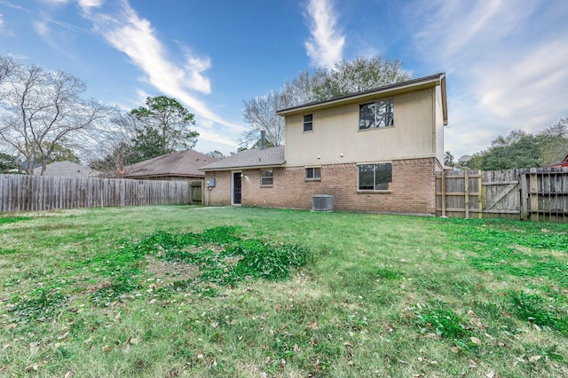 back of house featuring a yard and central AC unit