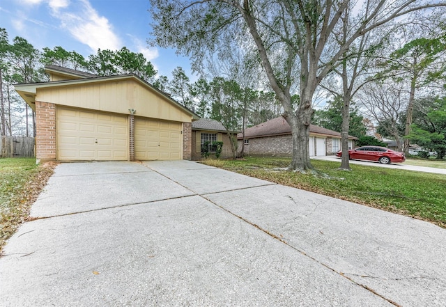 single story home with a garage and a front lawn