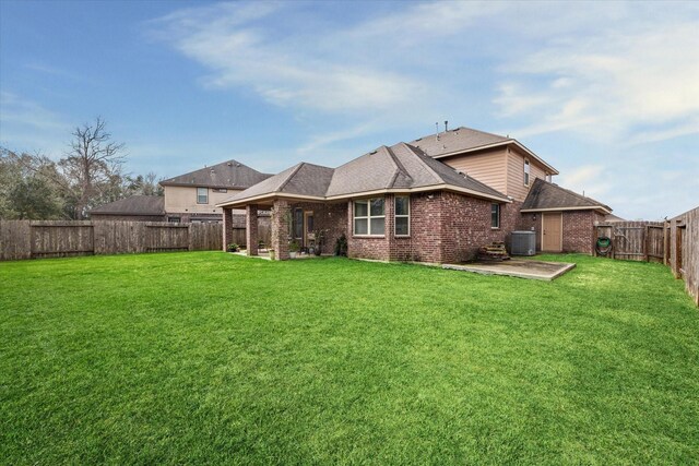 back of house featuring a yard, a patio, and central air condition unit