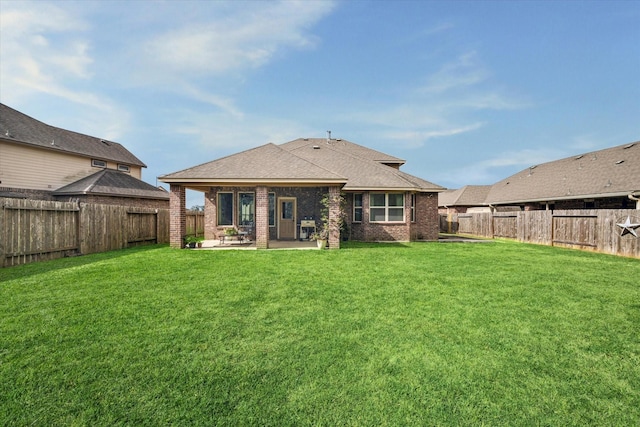 back of property with brick siding, a patio area, and a fenced backyard