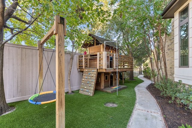 view of yard with a playground and a trampoline