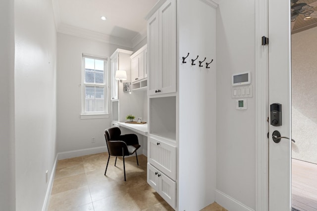 tiled office space with built in desk and ornamental molding