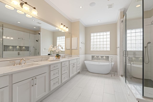 bathroom featuring ornamental molding, shower with separate bathtub, a healthy amount of sunlight, and vanity