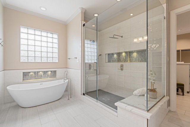 bathroom featuring crown molding, shower with separate bathtub, and tile walls