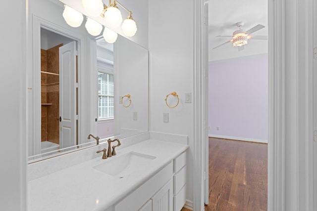 bathroom featuring vanity, hardwood / wood-style floors, and ceiling fan