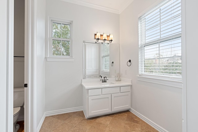 bathroom with vanity, ornamental molding, and toilet