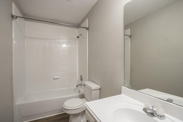 full bathroom with vanity, hardwood / wood-style floors, tiled shower / bath combo, and toilet