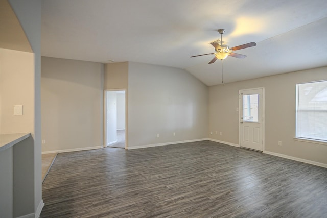 unfurnished living room featuring ceiling fan, dark hardwood / wood-style flooring, and vaulted ceiling