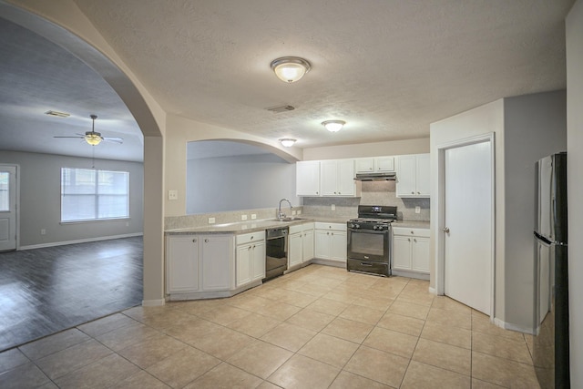 kitchen featuring sink, black appliances, backsplash, ceiling fan, and white cabinets