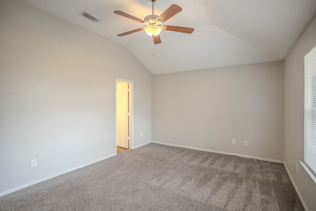 carpeted empty room with ceiling fan and vaulted ceiling