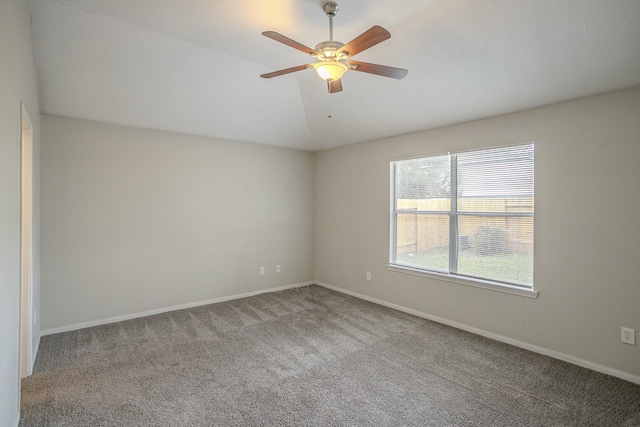 empty room with lofted ceiling, carpet flooring, and ceiling fan